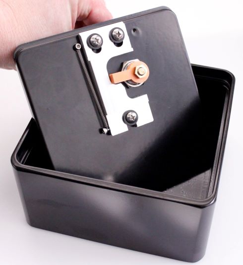 Hand holding the door to a black lock box